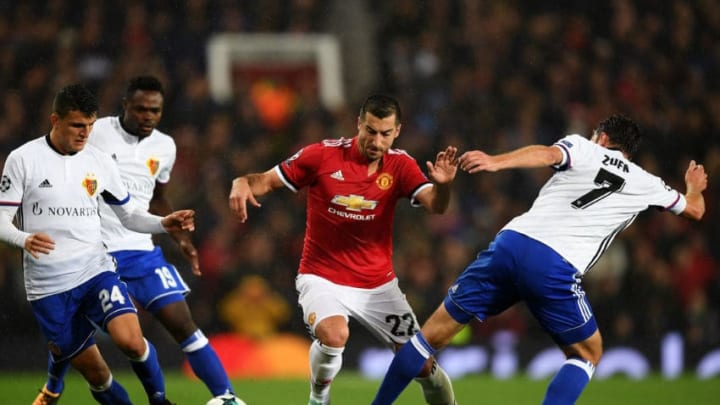 MANCHESTER, ENGLAND - SEPTEMBER 12: Henrikh Mkhitaryan of Manchester United attempts to get past Mohamed Elyounoussi of FC Basel and Luca Zuffi of FC Basel during the UEFA Champions League Group A match between Manchester United and FC Basel at Old Trafford on September 12, 2017 in Manchester, United Kingdom. (Photo by Shaun Botterill/Getty Images)