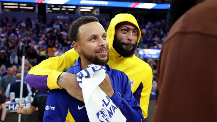 Anthony Davis of the Los Angeles Lakers hugs Stephen Curry of the Golden State Warriors as he talks with LeBron James after their game at Chase Center on October 07, 2023. (Photo by Ezra Shaw/Getty Images)