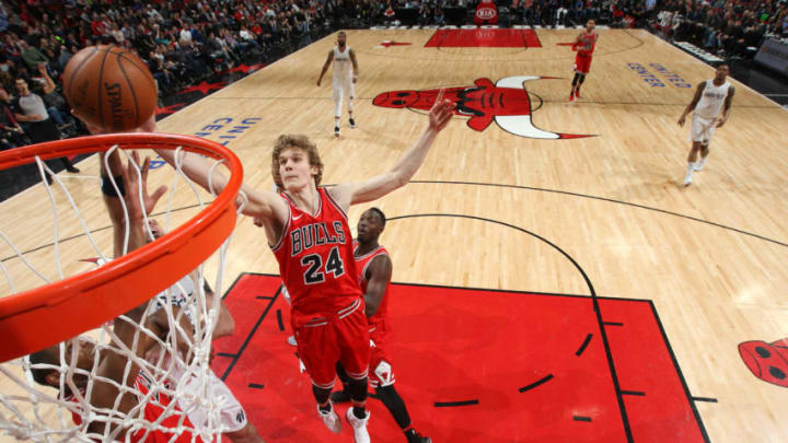 CHICAGO, IL - APRIL 1: Lauri Markkanen #24 of the Chicago Bulls grabs the rebound against the Washington Wizards on April 1, 2018 at the United Center in Chicago, Illinois. NOTE TO USER: User expressly acknowledges and agrees that, by downloading and/or using this photograph, user is consenting to the terms and conditions of the Getty Images License Agreement. Mandatory Copyright Notice: Copyright 2018 NBAE (Photo by Gary Dineen/NBAE via Getty Images)