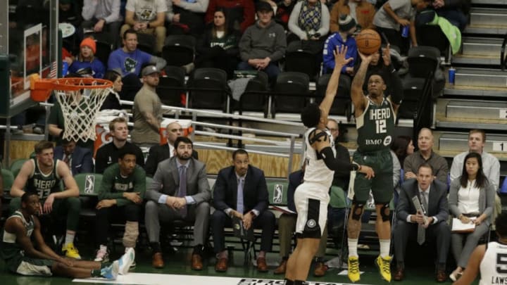 OSHKOSH, WI - DECEMBER 17: Rayjon Tucker #12 of the Wisconsin Herd shoot over the defense of the Austin Spurs NBA G-League game on December 17, 2019 at the Menominee Nation Arena in Oshkosh, Wisconsin. NOTE TO USER: User expressly acknowledges and agrees that, by downloading and or using this photograph, User is consenting to the terms and conditions of the Getty Images License Agreement. Mandatory Copyright Notice: Copyright 2019 NBAE (Photo by Mike E. Roemer/NBAE via Getty Images)