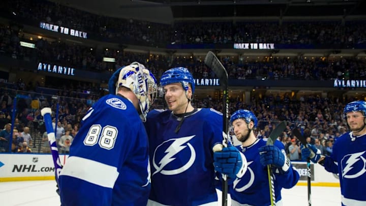 TAMPA, FL - MARCH 18: Andrei Vasilevskiy #88 of the Tampa Bay Lightning celebrates with Erik Cernak #81 after defeating the Arizona Coyotes 4-1 to win the Atlantic Division and the President's Trophy at Amalie Arena on March 18, 2019 in Tampa, Florida. (Photo by Scott Audette/NHLI via Getty Images)
