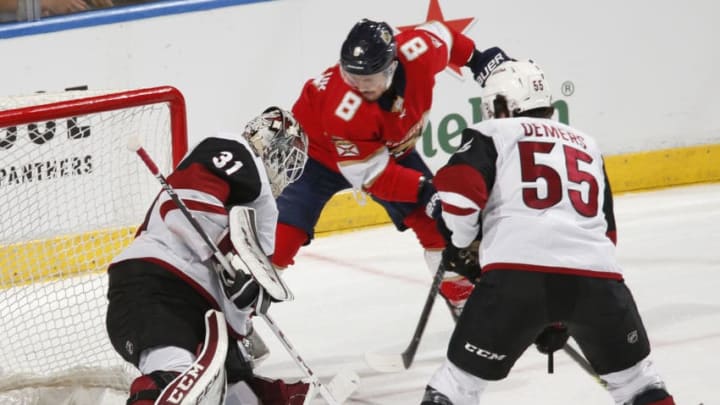 SUNRISE, FL - JANUARY 7: Jason Demers #55 looks on as Goaltender Adin Hill #31 of the Arizona Coyotes stops a shot by Jayce Hawryluk #8 of the Florida Panthers at the BB&T Center on January 7, 2020 in Sunrise, Florida. The Coyotes defeated the Panthers 5-2. (Photo by Joel Auerbach/Getty Images)