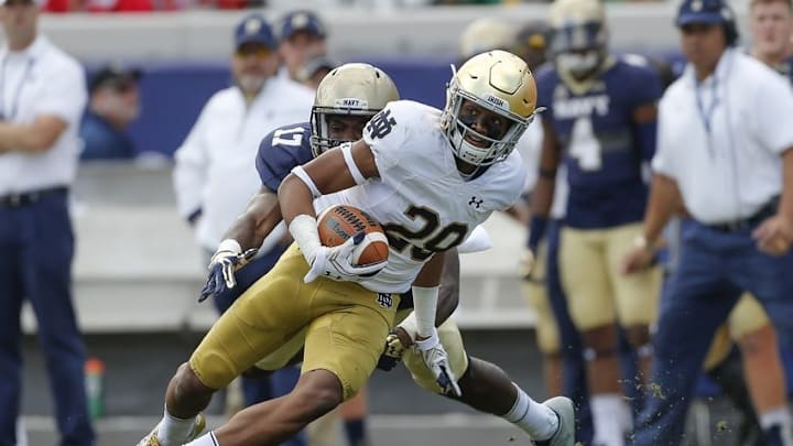 Nov 5, 2016; Jacksonville, FL, USA; Notre Dame Fighting Irish running back Austin Ross (28) runs after a catch in the second half as Navy Midshipmen cornerback Tyris Wooten (17) defends at Everbank Field. Navy Midshipmen won 28-27. Mandatory Credit: Logan Bowles-USA TODAY Sports