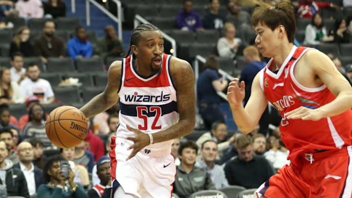 WASHINGTON, DC - OCTOBER 12: Jordan McRae #52 of the Washington Wizards dribbles past Yue Wang #32 of the Guangzhou Long-Lions during the second half at Capital One Arena on October 12, 2018 in Washington, DC. NOTE TO USER: User expressly acknowledges and agrees that, by downloading and or using this photograph, User is consenting to the terms and conditions of the Getty Images License Agreement. (Photo by Will Newton/Getty Images)