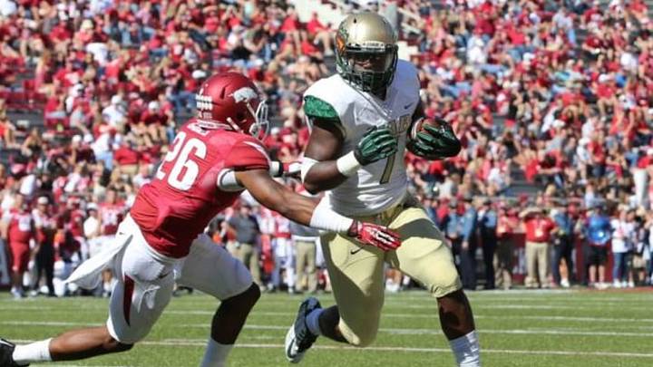 Oct 25, 2014; Fayetteville, AR, USA; UAB Blazers running back Jordan Howard (7) rushes as Arkansas Razorbacks safety Rohan Gaines (26) closes in at Donald W. Reynolds Razorback Stadium. Arkansas defeated UAB 45-17. Mandatory Credit: Nelson Chenault-USA TODAY Sports