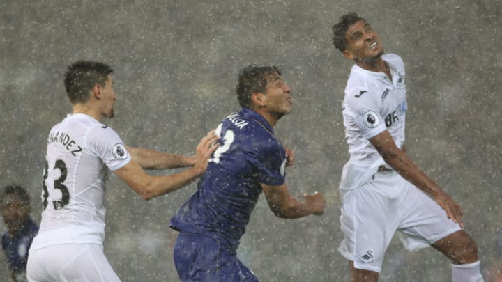 LEICESTER, ENGLAND - AUGUST 27: Leicester City's Leonardo Ulloa and Swansea City's Federico Fernandez in action during the torrential rain during the Premier League match between Leicester City and Swansea City at The King Power Stadium on August 27, 2016 in Leicester, England. (Photo by Rachel Holborn/CameraSport via Getty Images)