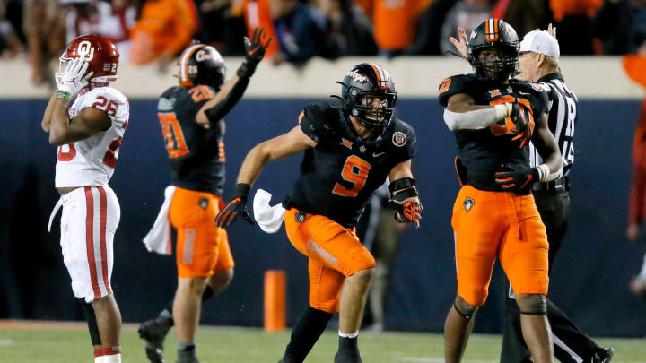 OSU’s Brock Martin (9) and Collin Oliver (30) celebrate beside OU’s Kennedy Brooks (26) after sacking Caleb Williams in the final minute of a 37-33 win last season in Stillwater.martin oliver