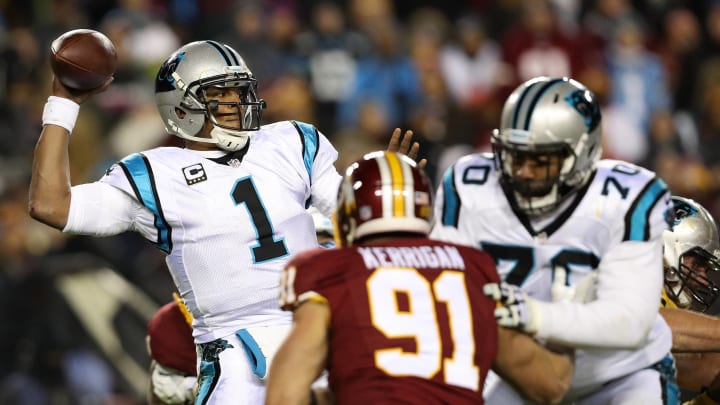 LANDOVER, MD – DECEMBER 19: Quarterback Cam Newton #1 of the Carolina Panthers passes the ball while teammate guard Trai Turner #70 blocks against outside linebacker Ryan Kerrigan #91 of the Washington Redskins in the second quarter at FedExField on December 19, 2016 in Landover, Maryland. (Photo by Patrick Smith/Getty Images)