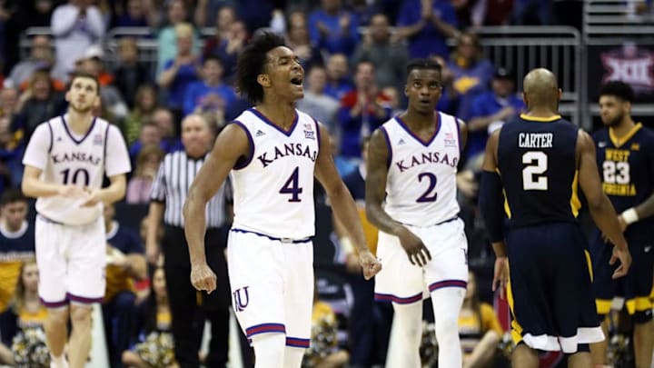 KANSAS CITY, MO - MARCH 10: Devonte' Graham #4 of the Kansas Jayhawks celebrate after scoring during the Big 12 Basketball Tournament Championship against the West Virginia Mountaineers game at Sprint Center on March 10, 2018 in Kansas City, Missouri. (Photo by Jamie Squire/Getty Images)