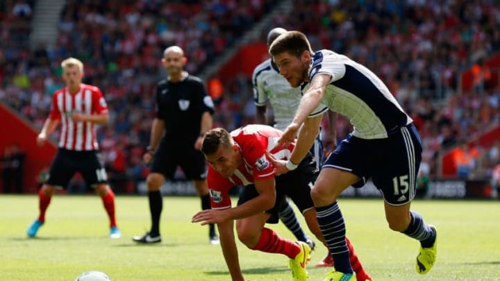 SOUTHAMPTON, ENGLAND - AUGUST 23: Dusan Tadic of Southampton and Sebastien Pocognoli of West Brom battle for the ball during the Barclays Premier League match between Southampton and West Bromwich Albion at St Mary's Stadium on August 23, 2014 in Southampton, England. (Photo by Steve Bardens/Getty Images)