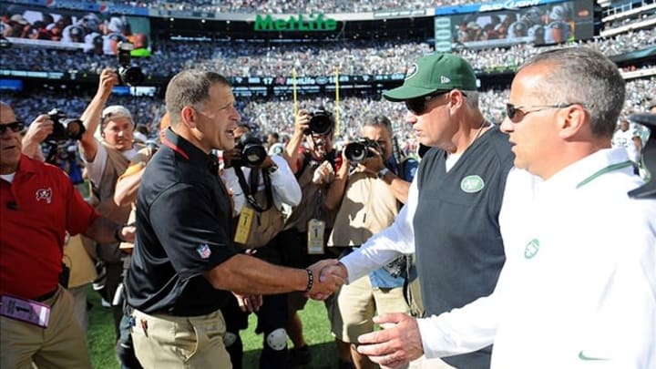 Sep 8, 2013; East Rutherford, NJ, USA; Tampa Bay Buccaneers head coach Greg Schiano (left) and New York Jets head coach Rex Ryan shake hands after the second half at MetLife Stadium. The Jets won 18-17. Mandatory Credit: Joe Camporeale-USA TODAY Sports
