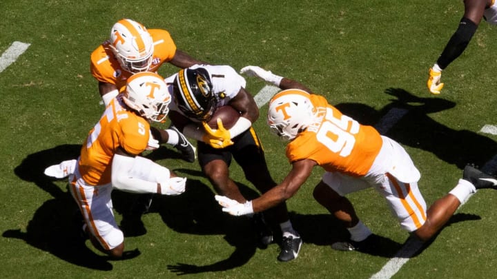 Tennessee defensive back Kenneth George Jr. (5) and Tennessee linebacker Kivon Bennett (95) tackle Missouri running back Tyler Badie (1) during a SEC conference football game between the Tennessee Volunteers and the Missouri Tigers held at Neyland Stadium in Knoxville, Tenn., on Saturday, October 3, 2020.Kns Ut Football Missouri Bp