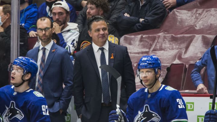 Oct 3, 2021; Vancouver, British Columbia, CAN; Vancouver Canucks assistant coach Jason King and head coach Travis Green on the bench against the Winnipeg Jets in the third period at Rogers Arena. Canucks won 3-2. Mandatory Credit: Bob Frid-USA TODAY Sports