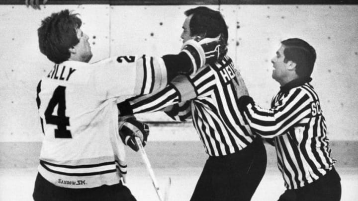 BOSTON, MA – APRIL 25: Boston Bruins player Terry O’Reilly, left, hits referee Andy Van Hellomond, center, during the 11th game of the NHL Stanley Cup Finals against the Quebec Nordiques at the Boston Garden in Boston on April 25, 1982. (Photo by Frank O’Brien/The Boston Globe via Getty Images)