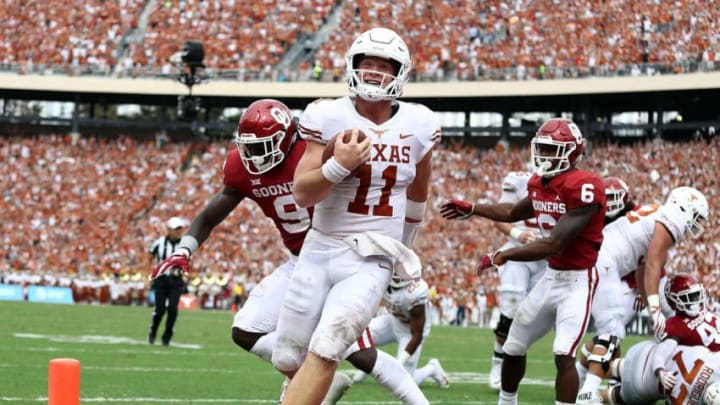 DALLAS, TX - OCTOBER 06: Sam Ehlinger #11 of the Texas Longhorns smiles as he runs into the endzone for a touchdown against the Oklahoma Sooners in the second quarter of the 2018 AT&T Red River Showdown at Cotton Bowl on October 6, 2018 in Dallas, Texas. (Photo by Ronald Martinez/Getty Images)