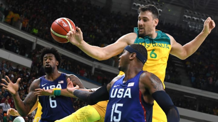 USA's centre DeAndre Jordan (L) and USA's forward Carmelo Anthony (C) reach for the ball with Australia's centre Andrew Bogut during a Men's round Group A basketball match between Australia and USA at the Carioca Arena 1 in Rio de Janeiro on August 10, 2016 during the Rio 2016 Olympic Games. / AFP / Mark RALSTON (Photo credit should read MARK RALSTON/AFP/Getty Images)