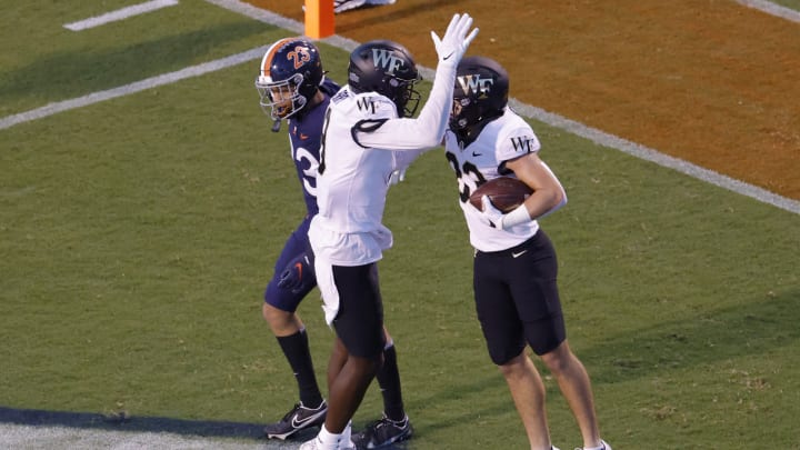 Sep 24, 2021; Charlottesville, Virginia, USA; Wake Forest Demon Deacons wide receiver Taylor Morin (83) celebrates with Demon Deacons wide receiver A.T. Perry (9) after catching a touchdown pass against the Virginia Cavaliers during the first quarter at Scott Stadium. Mandatory Credit: Geoff Burke-USA TODAY Sports