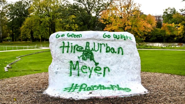 The Rock at Michigan State University is painted with a message supporting the hiring of former Ohio State football coach Urban Meyer on Friday, Oct. 6, 2023, in East Lansing. The text reads, “Go green, go white. Hire Urban Meyer, #RaiseTheFlag.”