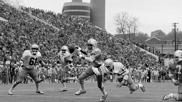 Tennessee quarterback Jimmy Streater, with the ball, runs into the end zone for the Vols first touchdown of the game in the first period against Notre Dame. Streater hurt his knee in the second period and sat out rest of the game, but Tennessee won a resounding upset of Notre Dame 40-18 before a record throng of 86,489 at Neyland Stadium Nov. 10, 1979.79then11 020