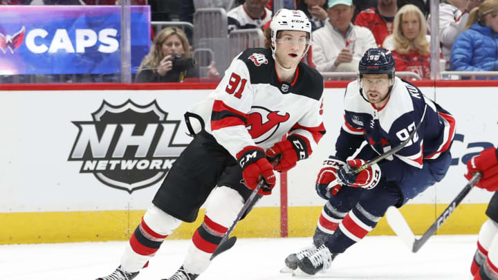 Mar 9, 2023; Washington, District of Columbia, USA; New Jersey Devils center Dawson Mercer (91) skates with the puck as Washington Capitals center Evgeny Kuznetsov (92) chases in the first period at Capital One Arena. Mandatory Credit: Geoff Burke-USA TODAY Sports