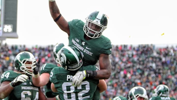 Nov 19, 2016; East Lansing, MI, USA; Michigan State Spartans running back LJ Scott (3) celebrates a touchdown with Michigan State Spartans tight end Josiah Price (82) during the second half of a game at Spartan Stadium. Mandatory Credit: Mike Carter-USA TODAY Sports