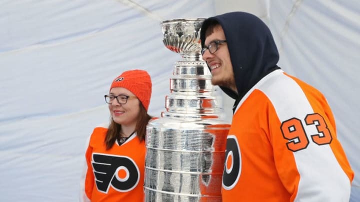 PHILADELPHIA, PA - APRIL 08: Fans have their photo taken with the Stanley Cup outside the NHL Centennial Truck Tour Museum prior to a NHL game between the Philadelphia Flyers and the Columbus Blue Jackets on April 8, 2017 at the Wells Fargo Center in Philadelphia, Pennsylvania. (Photo by Len Redkoles/NHLI via Getty Images)