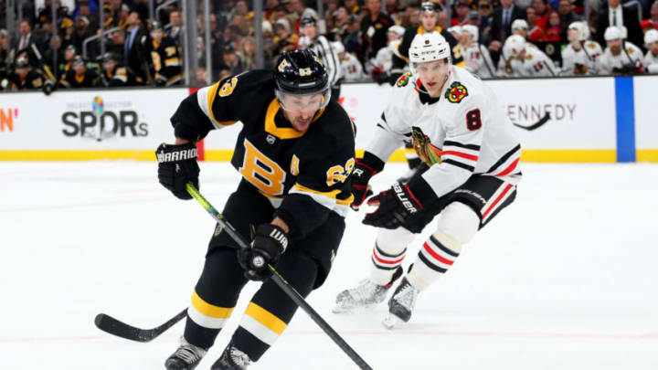 BOSTON, MASSACHUSETTS - DECEMBER 05: Brad Marchand #63 of the Boston Bruins skates against Dominik Kubalik #8 of the Chicago Blackhawks during the third period at TD Garden on December 05, 2019 in Boston, Massachusetts. (Photo by Maddie Meyer/Getty Images)