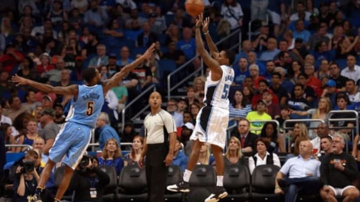 Mar 15, 2016; Orlando, FL, USA; Orlando Magic guard Brandon Jennings (55) shoots over Denver Nuggets forward Will Barton (5) during the second quarter at Amway Center. Mandatory Credit: Kim Klement-USA TODAY Sports