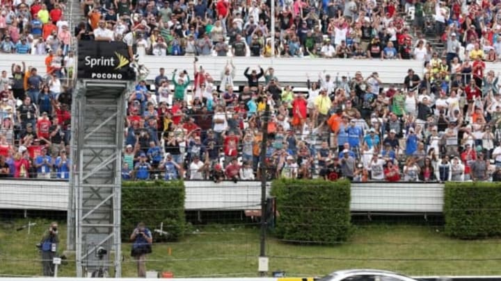 Aug 3, 2014; Long Pond, PA, USA; NASCAR Sprint Cup Series driver Dale Earnhardt Jr. (88) gets the checkered flag and wins the GoBowling.com 400 at Pocono Raceway. Mandatory Credit: Bill Streicher-USA TODAY Sports