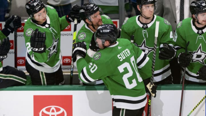 Apr 9, 2022; Dallas, Texas, USA; Dallas Stars left wing Jason Robertson (21) and center Luke Glendening (11) and defenseman Ryan Suter (20) after defenseman Miro Heiskanen (4) scores a power play goal against the New Jersey Devils during the second period at the at American Airlines Center. Mandatory Credit: Jerome Miron-USA TODAY Sports