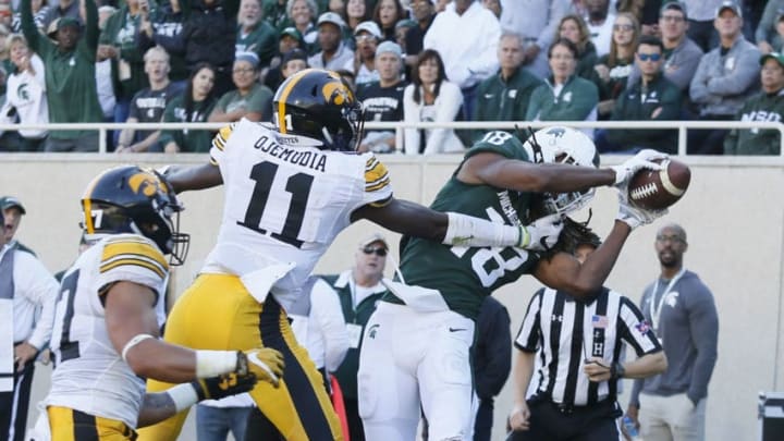 EAST LANSING, MI - SEPTEMBER 30: Wide receiver Felton Davis III #18 of the Michigan State Spartans catches his second touchdown pass of the first half against defensive back Michael Ojemudia #11 of the Iowa Hawkeyes and defensive back Amani Hooker #27 of the Iowa Hawkeyes on September 30, 2017 in East Lansing, Michigan. (Photo by Duane Burleson/Getty Images)