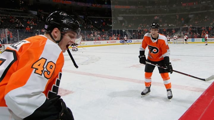 PHILADELPHIA, PA - NOVEMBER 23: Joel Farabee #49 and Morgan Frost #48 of the Philadelphia Flyers skate during warmups prior to their game against the Calgary Flames on November 23, 2019 at the Wells Fargo Center in Philadelphia, Pennsylvania. (Photo by Len Redkoles/NHLI via Getty Images)