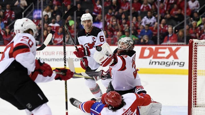 WASHINGTON, DC - MARCH 08: T.J. Oshie #77 of the Washington Capitals and Mackenzie Blackwood #29 of the New Jersey Devils collide in the first period at Capital One Arena on March 8, 2019 in Washington, DC. (Photo by Patrick McDermott/NHLI via Getty Images)