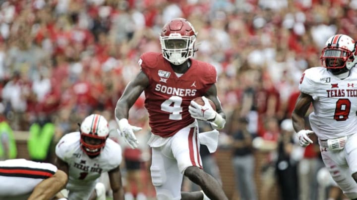 NORMAN, OK - SEPTEMBER 28: Running back Trey Sermon #4 of the Oklahoma Sooners scrambles against the defense of the Texas Tech Red Raiders at Gaylord Family Oklahoma Memorial Stadium on September 28, 2019 in Norman, Oklahoma. The Sooners defeated the Red Raiders 55-16. (Photo by Brett Deering/Getty Images)