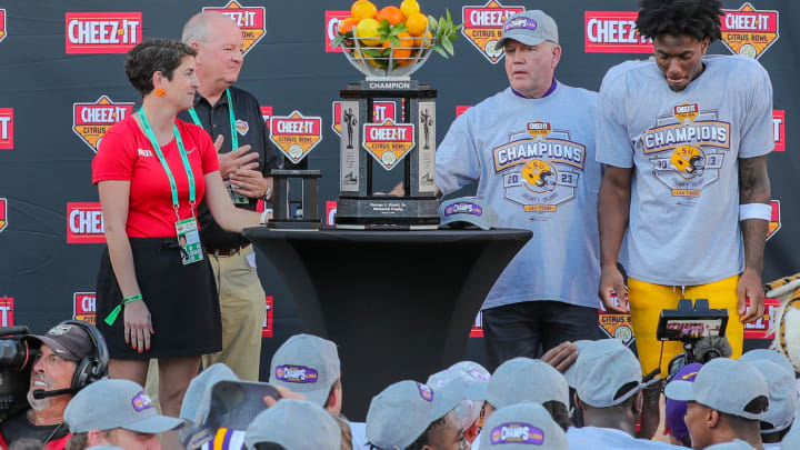 Jan 2, 2023; Orlando, FL, USA; LSU Tigers head coach Brian Kelly, wide receiver Malik Nabers (8) (game MVP), and Florida Citrus Sports officials pose with the trophy after the game against the Purdue Boilermakers at Camping World Stadium. Mandatory Credit: Mike Watters-USA TODAY Sports