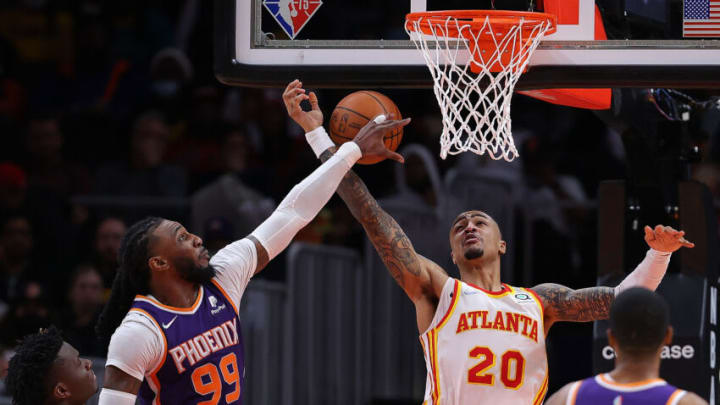 ATLANTA, GEORGIA - FEBRUARY 03: Jae Crowder #99 of the Phoenix Suns blocks a shot by John Collins #20 of the Atlanta Hawks during the second half at State Farm Arena on February 03, 2022 in Atlanta, Georgia. NOTE TO USER: User expressly acknowledges and agrees that, by downloading and or using this photograph, User is consenting to the terms and conditions of the Getty Images License Agreement. (Photo by Kevin C. Cox/Getty Images)