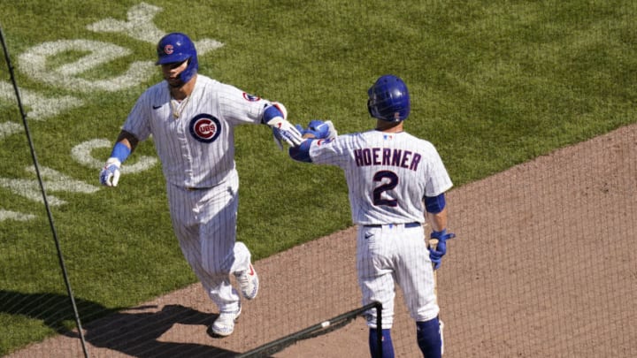 CHICAGO, ILLINOIS - JULY 26: Willson Contreras #40 of the Chicago Cubs is congratulated by Nico Hoerner #2following his home run against the Milwaukee Brewers during the seventh inning of a game at Wrigley Field on July 26, 2020 in Chicago, Illinois. (Photo by Nuccio DiNuzzo/Getty Images)