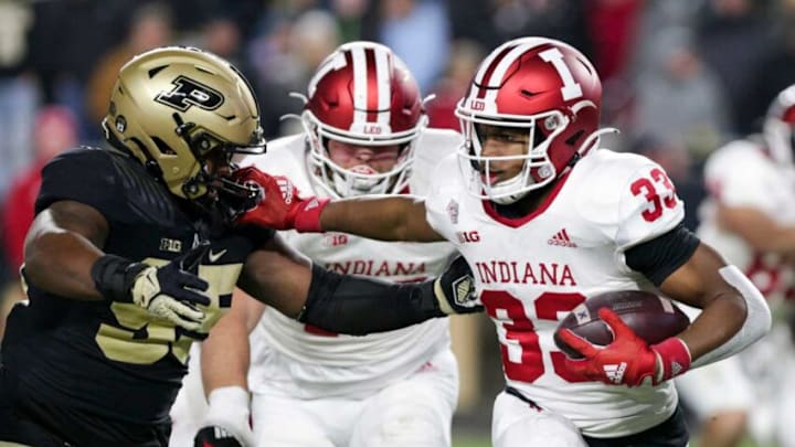 Indiana running back David Holloman (33) stiff arms Purdue defensive end Joe Anderson (95) during the fourth quarter of an NCAA college football game, Saturday, Nov. 27, 2021 at Ross-Ade Stadium in West Lafayette.Cfb Purdue Vs Indiana