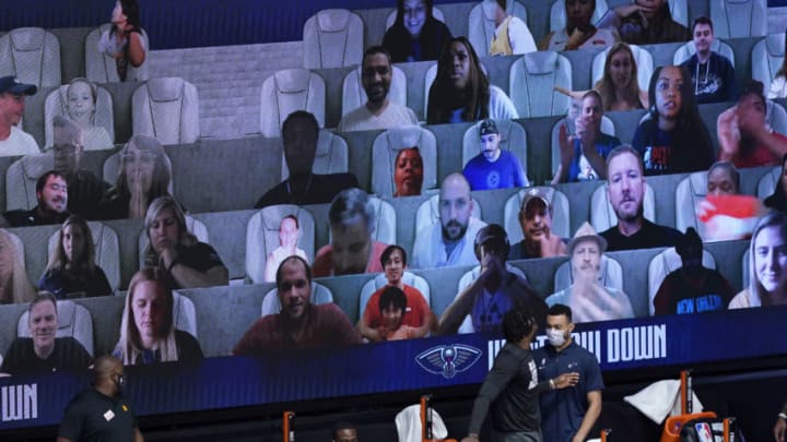 Photos of fans are seen on screens during the second half of an NBA game between the New Orleans Pelicans and the Utah Jazz (Photo by Ashley Landis-Pool/Getty Images)