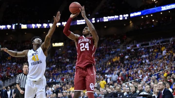 Mar 11, 2016; Kansas City, MO, USA; Oklahoma Sooners guard Buddy Hield (24) shoots a jump shot as West Virginia Mountaineers forward Devin Williams (41) defends in the second half during the Big 12 Conference tournament at Sprint Center. West Virginia won 69-67. Mandatory Credit: Denny Medley-USA TODAY Sports
