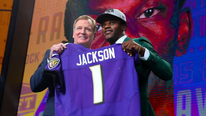 ARLINGTON, TX - APRIL 26: Lamar Jackson holds up a jersey with NFL Commissioner Roger Goodell after being chosen by the Baltimore Ravens with the 32nd pick during the first round at the 2018 NFL Draft at AT