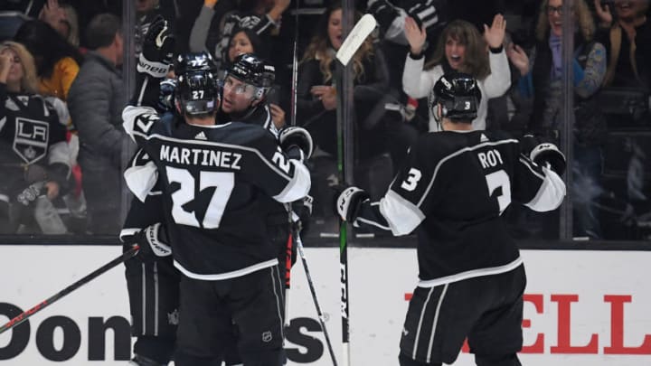 LOS ANGELES, CALIFORNIA - NOVEMBER 14: Adrian Kempe #9 of the Los Angeles Kings celebrates his goal with Jeff Carter #77, Alec Martinez #27 and Matt Roy #3, to tie the game 2-2 with the Detroit Red Wings, during a 3-2 Kings overtime win at Staples Center on November 14, 2019 in Los Angeles, California. (Photo by Harry How/Getty Images)