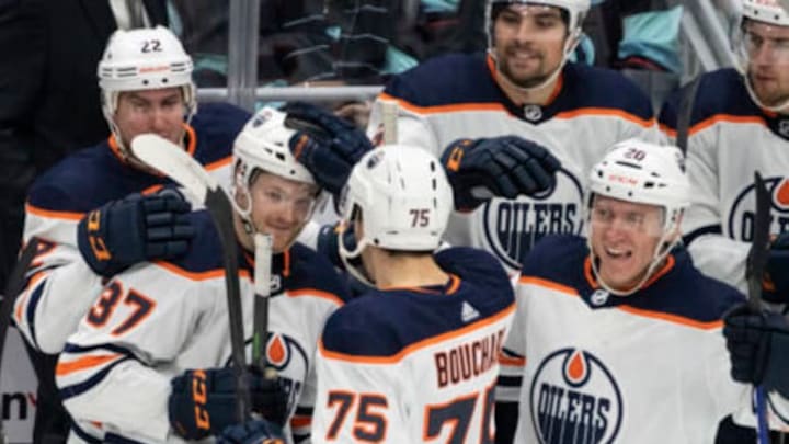 Dec 18, 2021; Seattle, Washington, USA; Edmonton Oilers left wing Warren Foegele (37) is congratulated by teammates, including defenseman Tyson Barrie (22), defenseman Evan Bouchard (75), and defenseman Slater Koekkoek (20) after scoring a goal against the Seattle Kraken at Climate Pledge Arena. Mandatory Credit: Stephen Brashear-USA TODAY Sports