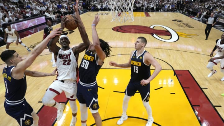 MIAMI, FLORIDA - JUNE 09: Jimmy Butler #22 of the Miami Heat drives to the basket against Michael Porter Jr. #1 and Aaron Gordon #50 of the Denver Nuggets in Game Four of the 2023 NBA Finals at Kaseya Center on June 09, 2023 in Miami, Florida. NOTE TO USER: User expressly acknowledges and agrees that, by downloading and or using this photograph, User is consenting to the terms and conditions of the Getty Images License Agreement. (Photo by Wilfredo Lee - Pool/Getty Images)