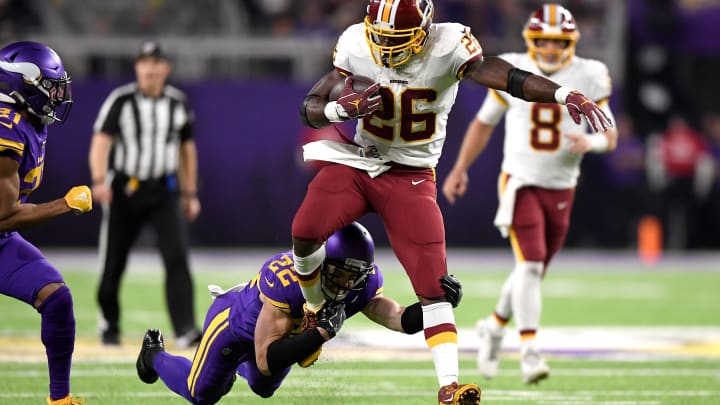 MINNEAPOLIS, MINNESOTA – OCTOBER 24: Running back Adrian Peterson #26 of the Washington Redskins is tackled by Harrison Smith #22 of the Minnesota Vikings during the game at U.S. Bank Stadium on October 24, 2019 in Minneapolis, Minnesota. (Photo by Hannah Foslien/Getty Images)