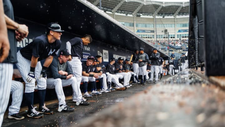 Yankee players wait out rain in their dugout. The Yanks had an 8-0 lead washed away in mid week simulated action. (Photo by Mark Brown/Getty Images)