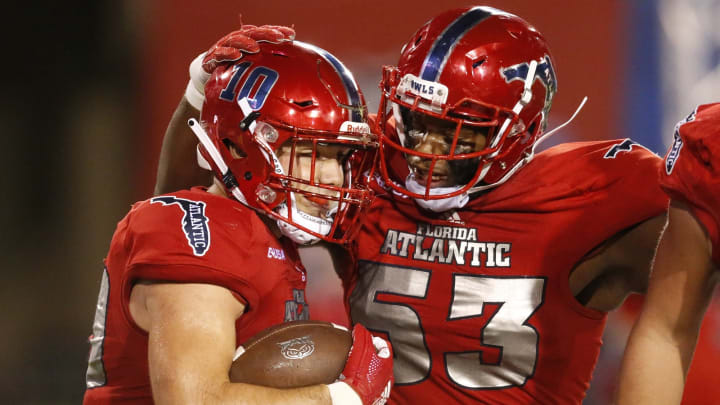 BOCA RATON, FL – NOVEMBER 24: John Raine #10 is congratulated by Antonio Riles #53 of the Florida Atlantic Owls after scoring a second quarter touchdown against the Charlotte 49ers on November 24, 2018 at FAU Stadium in Boca Raton, Florida. (Photo by Joel Auerbach/Getty Images)