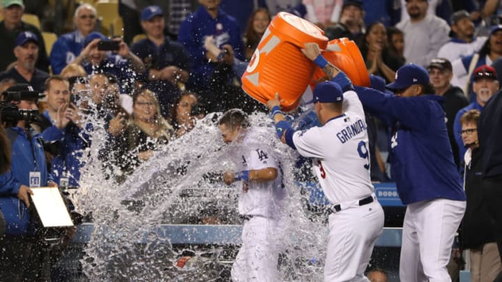 LOS ANGELES, CA - MAY 09: Yasmani Grandal #9 and Kenley Jansen #74 of the Los Angeles Dodgers douse teammate Austin Barnes #15 with water after Barnes hit the game-winning rbi in the tenth inning of the MLB game against the Pittsburgh Pirates at Dodger Stadium on May 9, 2017 in Los Angeles, California. The Dodgers defeated the Pirates 4-3 in the tenth inning. (Photo by Victor Decolongon/Getty Images)