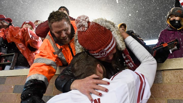 MINNEAPOLIS, MINNESOTA – NOVEMBER 30: Quarterback Jack Coan #17 of the Wisconsin Badgers celebrates defeating the Minnesota Golden Gophers with fans after the game at TCF Bank Stadium on November 30, 2019, in Minneapolis, Minnesota. The Badgers defeated the Golden Gophers 38-17. (Photo by Hannah Foslien/Getty Images)