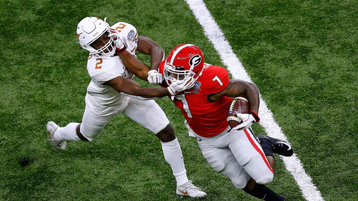 NEW ORLEANS, LOUISIANA – JANUARY 01: D’Andre Swift #7 of the Georgia Bulldogs runs with the ball as Kris Boyd #2 of the Texas Longhorns defends during the first half of the Allstate Sugar Bowl at the Mercedes-Benz Superdome on January 01, 2019 in New Orleans, Louisiana. (Photo by Jonathan Bachman/Getty Images)